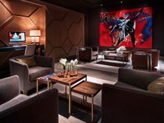 
                    
                        The Quin Hotel New York // Dark, dramatic seating area with red painting.
                    
                