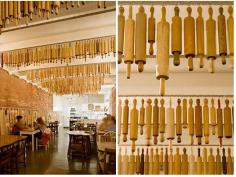 
                    
                        Rows of vintage wooden rolling pins decorate the ceiling of Pizza Farro, in Thornbury, Australia.
                    
                