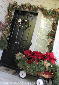 
                        
                            Radio flyer wagon full of poinsettias on the front porch
                        
                    