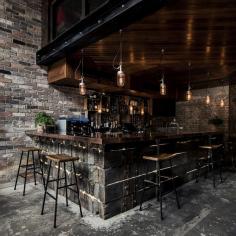 The bar downstairs is made of reclaimed railway sleepers that have been lashed together with ratchet straps, and it’s topped with a lovely polished copper top that zings against the weathered wood. A mezzanine level set back from the entrance opens up the space to its full cavernous effect...