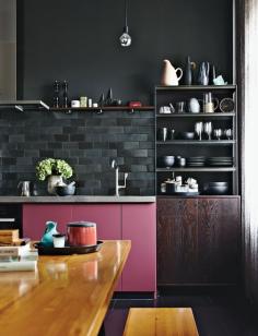 
                    
                        The kitchen cabinets benefit from a pop of rosy color, a custom hue.
                    
                