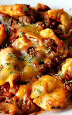 
                    
                        Cheesy Crockpot Tortellini ~ The meat sauce cooks all day and is rich and flavorful once it’s time to eat. Add in some tortellini, top with cheese, cook a bit longer, and voila… Mmmm delicious!
                    
                