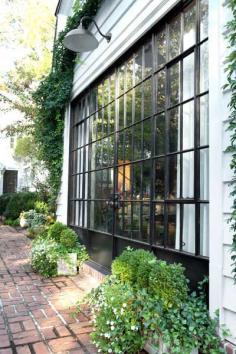 
                    
                        Guest House with large vintage-window-inspired doors leading to the garden
                    
                