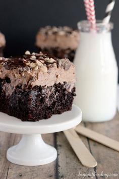 
                    
                        Sinful Triple Chocolate Poke Cake with a chocolate whipped cream frosting.
                    
                