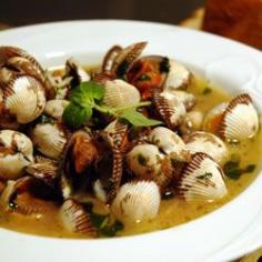 THESE CLAMS ARE STEAMED IN WINE, BUTTER, AND SPICES. WHEN THE CLAMS ARE GONE, DIP ITALIAN BREAD IN THE BROTH.