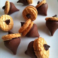 Cute fall treat idea. Acorns! It's a mini nutter butter cookie, a Hershey kiss and a chocolate chip.