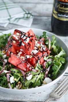 Watermelon and Balsamic Arugula Salad.  A refreshing salad recipe featuring watermelon, pickled onions, feta cheese, pine nuts, and a sweet honey balsamic reduction. Now that's a spring salad.