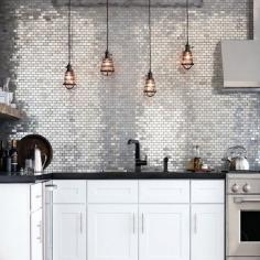 
                    
                        Kitchen with silver metallic accent wall and backsplash.
                    
                