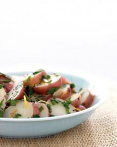 New Potato Salad : This French-style potato salad is traditionally made with white wine; we've used lemon juice and zest instead, lending the results a tangy freshness. This recipe calls for new potatoes because they hold their shape well as they're steamed and mixed. We chose red potatoes; white would be fine, too.