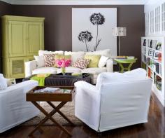 Family room decorating ideas- the dark wall color works with the white built- in, white furniture, and large white art work.