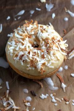 Glazed Coconut Donuts - These soft, fluffy donuts are baked, not fried, and full of coconut flavor! So easy to make at home, and a zillion times tastier than any bakeries!