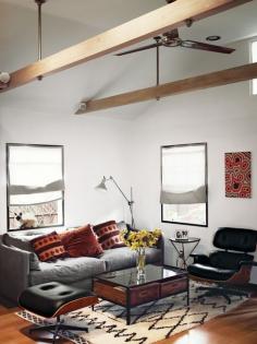 
                    
                        In the living area of actor Vincent Kartheiser’s Hollywood cabin, redesigned by Funn Roberts to maximize every last inch of space, an Eames lounge chair and ottoman mix with a couch and coffee table by Cisco Home from HD Buttercup. The table in the main room is from West Elm.
                    
                