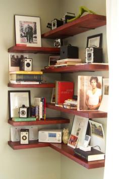 A fun modern looking shelf.  DIY corner shelving, #books #bookshelves floating shelves, red shelves. Display for vintage cameras.