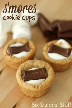 
                    
                        S'mores Cookie Cups from SixSistersStuff.com.  A graham cracker cookie crust filled with gooey marshmallow and topped with chocolate! #sixsistersstuff #recipe
                    
                