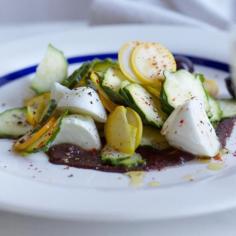 
                    
                        Mozzarella with Summer Squash and Olive Puree | This dish from chef Mathieu Perez is a take on the classic Italian mozzarella-tomato-basil Caprese salad. It depends on young, very fresh zucchini and summer squash. To prepare the recipe like Perez, grate the olives finely with a Microplane grater instead of pureeing them.
                    
                