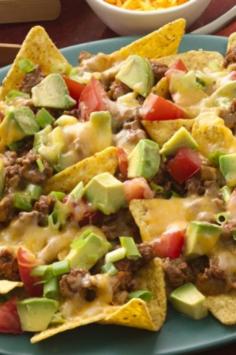 
                    
                        Add sour cream and diced avocados after removing nachos from oven.
                    
                