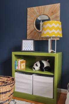 
                    
                        Navy, green, and gray boy's nursery ideas with natural wood accents
                    
                