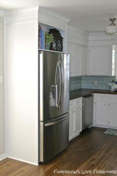 fridge enclosure - vinyl plank flooring - white cabinets - kitchen makeover, Fisherman's Wife Furniture featured on Remodelaholic.com  Beautiful small kitchen!