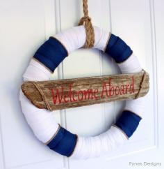 #Nautical #wreath made with May Arts ribbons. Driftwood board in the center says "Welcome Aboard"> Fynes Designs. This could be recreated with a pool noodle as a thrifty sailing accent to a boy's bedroom!
