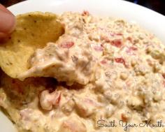 Creamy Rotel  Sausage Dip with Tortilla Chips  1 pound pork sausage  2 8-ounce packages cream cheese, at room temperature  2 10-ounces cans diced tomatoes and green chilies (such as Rotel), well drained  1/2 teaspoon garlic salt