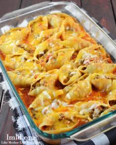 Mexican Stuffed Shells Recipe ~ filled with a ground beef and cream cheese mixture, cooked in a bath of enchilada sauce and salsa topped with cheddar cheese.
