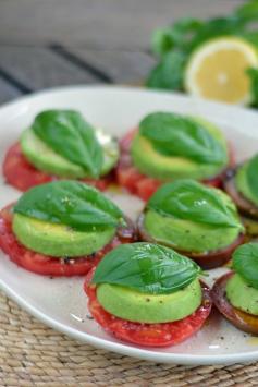 A paleo take on a Caprese salad with tomatoes and basil fresh from the garden. Heirloom tomato avocado salad is the perfect appetizer or lunch.