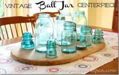 
                    
                        Group vintage ball jars and a few glass insulators on an old bread board to make a centerpiece for your table.  virginiasweetpea.com
                    
                
