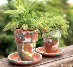 Nail Polish-Marbled Painted Garden Pots -- you'll never guess what's used to paint these pots! You no doubt have some at home. Genius!