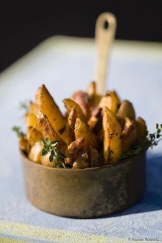 potato wedges + herbs in small copper pan.