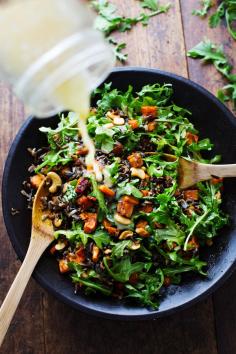 Roasted Sweet Potato, Wild Rice, and Arugula Salad Recipe. Served with a simple lemon and olive oil dressing. Also has cashew pieces. "I licked the plate clean." From Pinch of Yum.