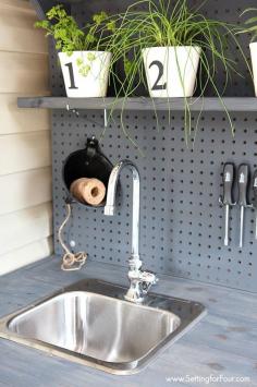 Organize all of your gardening tools, supplies and containers with this DIY pallet potting bench made from free pallet wood! Pot flowers, plants and herbs easily with running water hookup! www.settingforfour.com