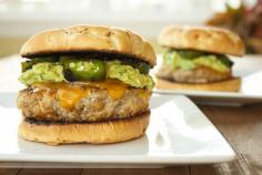 Guacamole Burger with Roasted Jalapeno Peppers and cheddar cheese on a toasted onion bun