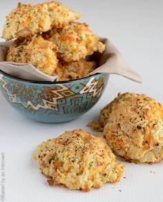 Quick and easy biscuits filled with cheddar cheese, zucchini, and sun dried tomatoes. These cheesy zucchini tomato drop biscuits are great for a dinner party or afternoon picnic. They come together in a snap and require no rolling or cutting. | @introvertbaker at bakedbyanintrovert.com