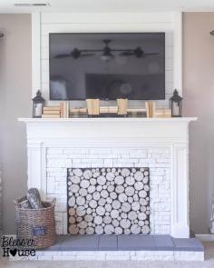 faux fireplace with storage inside and books to hide cords, use IR remote (Blesser House on Remodelaholic)