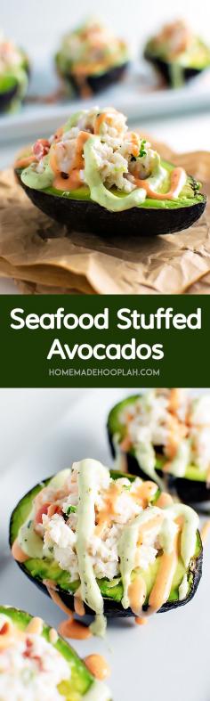Seafood Stuffed Avocados! Halved avocados filled with shrimp, crab, and tomato and then drizzled with sriracha and avocado cream on top.