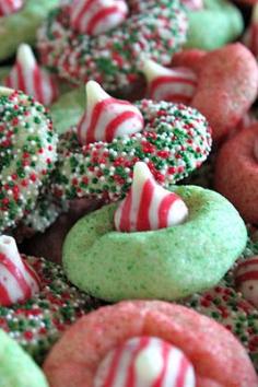 Roll sugar cookie dough in sprinkles or colored sugar before baking. When mostly cooled, smash kisses on top. "Candy Cane Blossoms II" from Baked Perfection blog.