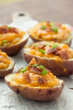 Grilled BBQ Bacon Twice Baked Potatoes: Tender potato shells stuffed with mashed potatoes flavored with barbecue sauce, bacon and cheddar cheese, and grilled to perfection! Microwaving the potatoes keeps things super easy and keeps the house cool in the summer. You can also bake them in the oven if you desire.