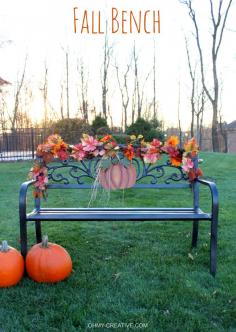 Use a pretty garland and metal pumpkin to create this easy to Decorate a Fall Outdoor Bench  |  OHMY-CREATIVE.COM