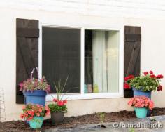 lovely new Home Depot windows -- and diy shutters! Cute for a basement window!