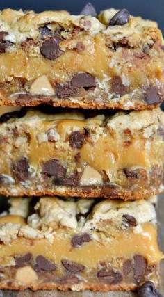 Your life will never be the same after you try these Peanut Butter Caramel Toffee Chocolate Chip Cookie Bars! An amazing dessert recipe that tastes like a million bucks and is SO easy! | MomOnTimeout.com | #chocolate