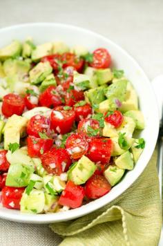 One of my FAVORITE summer dishes! Tomato cucumber avocado salad. So colorful, flavorful and easy too! | www.deliciousmeetshealthy.com #avocado #tomato #paleo #glutenfree #salad #summer #BBQ #grilling #cucumber #healthy