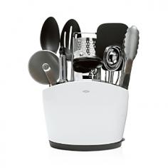 Keep all the essential kitchen tools within quick reach with this set from OXO. Collection includes 9" locking tongs, small nylon spoon and slotted spoon, nylon flexible turner, swivel peeler, soft-handled can opener, ice cream scoop, grater and pizza wheelâ plus a slim, space-efficient utensil holder to contain them all. From outfitting a first kitchen to expanding a supply of tools, this assortment brings function and style to any kitchen. All feature soft, non-slip handles, sturdy stainless steel, and heat-resistant nylon. The large-capacity utensil holder even has a removable drip tray. All are dishwasher safe, but we recommend hand washing the can opener. Web only.