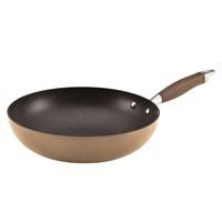 Versatile pan with heavy-duty, hard-anodized construction. Bronze-hued finish with nonstick interior. Interior is metal utensil-safe and provides easy cleanup. Dual-riveted, rubberized handle provides a confident grasp. Oven safe to 400 degrees F. We don't know the date that we officially borrowed stir-frying from the Far East, but when you have the Anolon Advanced Bronze Hard-Anodized Nonstick 12 in. Stir Fry Pan, it's always the first of Wok-tober. From linguini with bay scallops to stir fries created with farmer's market vegetables, the pan's heavy-duty, hard-anodized construction provides efficient and even heat distribution to help reduce hot spots that can burn foods. It boasts a warm bronze nonstick exterior coupled with a deep chocolate interior and a softly flared tulip-shaped profile. Restaurant tested by professional chefs - DuPont's Autograph 2 nonstick surface inside delivers superior durability that stands up to the rigors of a professional kitchen. Ideal for easy cleanup, this versatile pan is even safe for use with metal utensils. A revolutionary Anolon SureGrip handle features comfortable rubber over durable stainless steel for a confident grip and is dual riveted for added strength. About Anolon CookwareFor those who think recipes are more like suggestions, meet Anolon - a leading brand of gourmet cookware designed to empower food enthusiasts to creatively express themselves in the kitchen. Anolon gives home cooks the ability to cook outside the recipe by offering a wide selection of high-performance, exceptionally crafted cookware, bakeware, cutlery, tools and gadgets that satisfy the needs of each home chef's unique cooking style. Celebrate creativity in the kitchen with Anolon.
