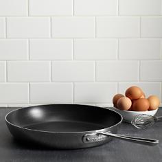 The French Skillet features a large surface area and round sides that hold in heat and liquids while preventing splattering, making the pan ideal for searing, browning and pan frying a wide range of foods, including eggs and meats. The round sides allow for large quantities of food to be easily flipped and facilitates easy basting while cooking, yielding superb results full of flavor and color. All-Clad nonstick ensures effortless cleaning. Premium tri-ply construction delivers even heat distribution. Engraved capacity marking on the bottom of the pan. Riveted long stick handle stays cool on the cooktop. Durable PFOA-free nonstick coating. Works on all cooktops, induction included. 7" diameter. Made in the U.S.A.
