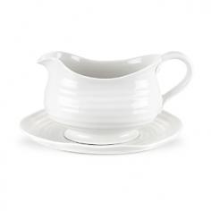 Durable porcelain construction. Strong and durable yet lightweight. Modern, organic rim styling and ridges. Microwave- and dishwasher-safe. Dimensions: 9.5L x 4W x 5H inches. The Sophie Conran White Gravy Boat and Stand is a practical, yet stylish way to serve up gravy, sauces, and more. Crafted of durable porcelain, this set will blend perfectly with the rest of your dinnerware. Plus, it is safe for the freezer, microwave, oven and dishwasher, making it perfect for a number of uses. About PortmeirionStrikingly beautiful, eminently practical, refreshingly affordable. These are the enduring values bequeathed to Portmeirion by its legendary co-founder and designer, Susan Williams-Ellis. Her father, architect Sir Clough Williams-Ellis, was the designer of Portmeirion, the North Wales village whose fanciful architecture has drawn tourists and artists from around the world (including the creators of the classic 1960s TV show The Prisoner). Inspired by her fine arts training and creation of ceramic gifts for the village's gift shop, Susan Williams-Ellis (along with her husband Euan Cooper-Willis) founded Portmeirion Pottery in 1960. After 50+ years of innovation, the Portmeirion Group is not only an icon of British design, but also a testament to the extraordinarily creative life of Susan Williams-Ellis. The style of Portmeirion dinnerware and serveware is marked by a passion for both pottery manufacturing and trend-setting design. Beautiful, tactile, nature-inspired patterns are a defining quality of Portmeirion housewares, from its world-renowned botanical designs modeled on antiquarian books to the breezy, natural colors of its porcelain and earthenware. Today, the Portmeirion Group's design legacy continues to evolve, through iconic brands such as Spode, the Pomona Classics collection, and the award-winning collaboration of Sophie Conran for Portmeirion. Sophie Conran for Portmeirion: Successful collaborations have provided design inspiration throughout Sophie Conran's life. Her father, designer Sir Terence Conran, and mother, food writer Caroline Conran, have been the pillars of her eclectic mix of cooking, writing, and interior design. In pairing with the iconic British housewares brand Portmeirion, Conran has created another successful collaboration: Sophie Conran for Portmeirion, an award-winning collection of dinnerware, serveware, and drinkware for the practical, multi-functional needs of contemporary kitchens. Launched in 2006, Sophie Conran for Portmeirion immediately received the Elle Deco Style Award for Best in Kitchens, and two years later, the House Beautiful Award for Best in Tableware. The soulful, tactile beauty of these oven-to-tableware pieces is exemplified by rippled surfaces and edges that evoke a potter's hand. This down-to-earth style is complemented by charming pastels, gentle earth tones, and classic whites and pinks, for a collection that will lighten and enliven contemporary kitchen decors. Though delicate to the eye and touch, these plates and bowls are built for durable performance, with microwave- and dishwasher-safe porcelain that's casual enough for breakfast and elegant enough for eye-catching dinners.